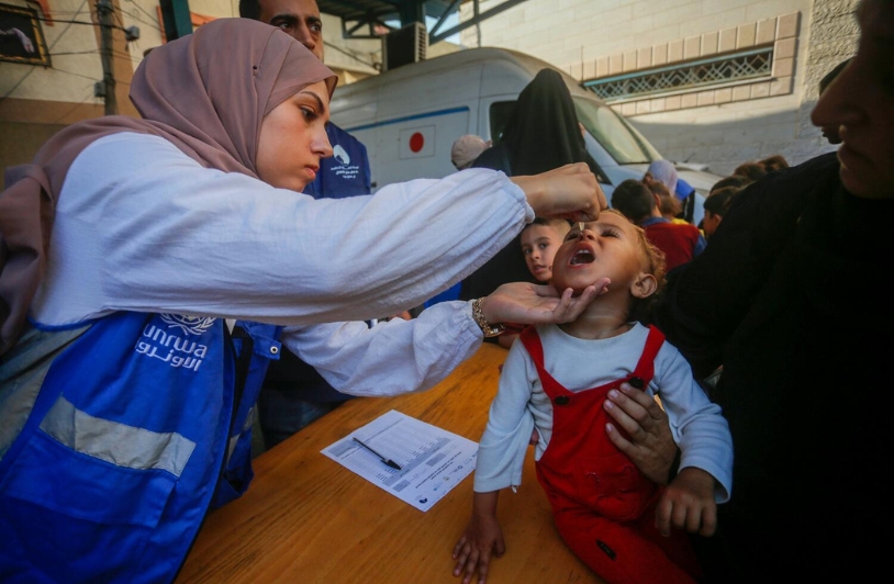 woman helping a young child in Gaza