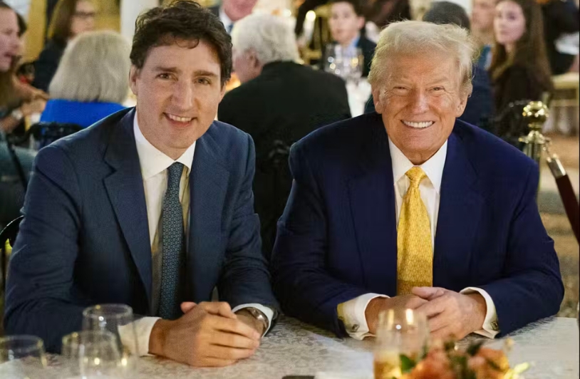 Donald Trump and Justin Trudeau smiling at camera.